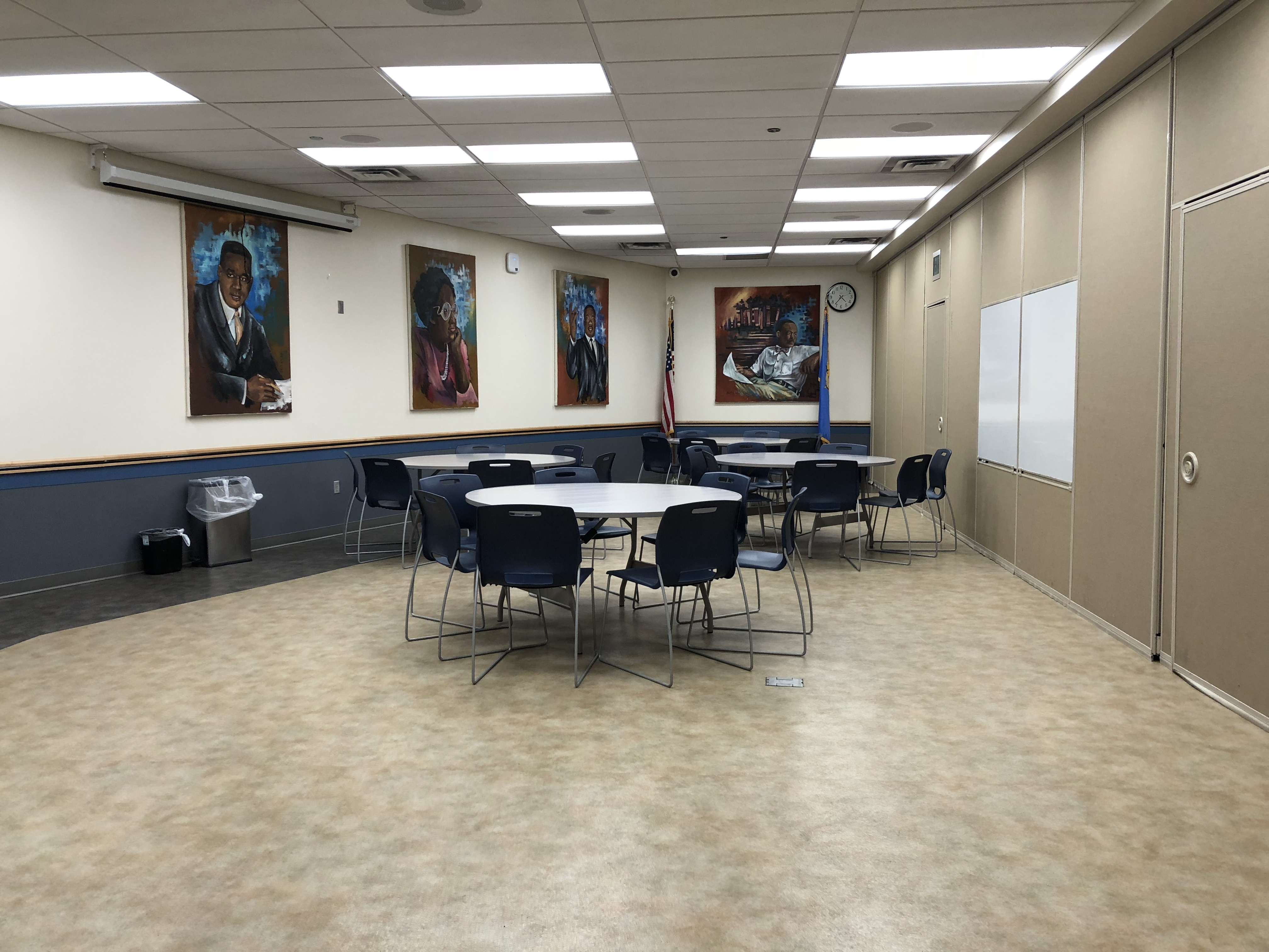 Meeting Room A at Ralph Ellison Library equipped with circular tables and chairs