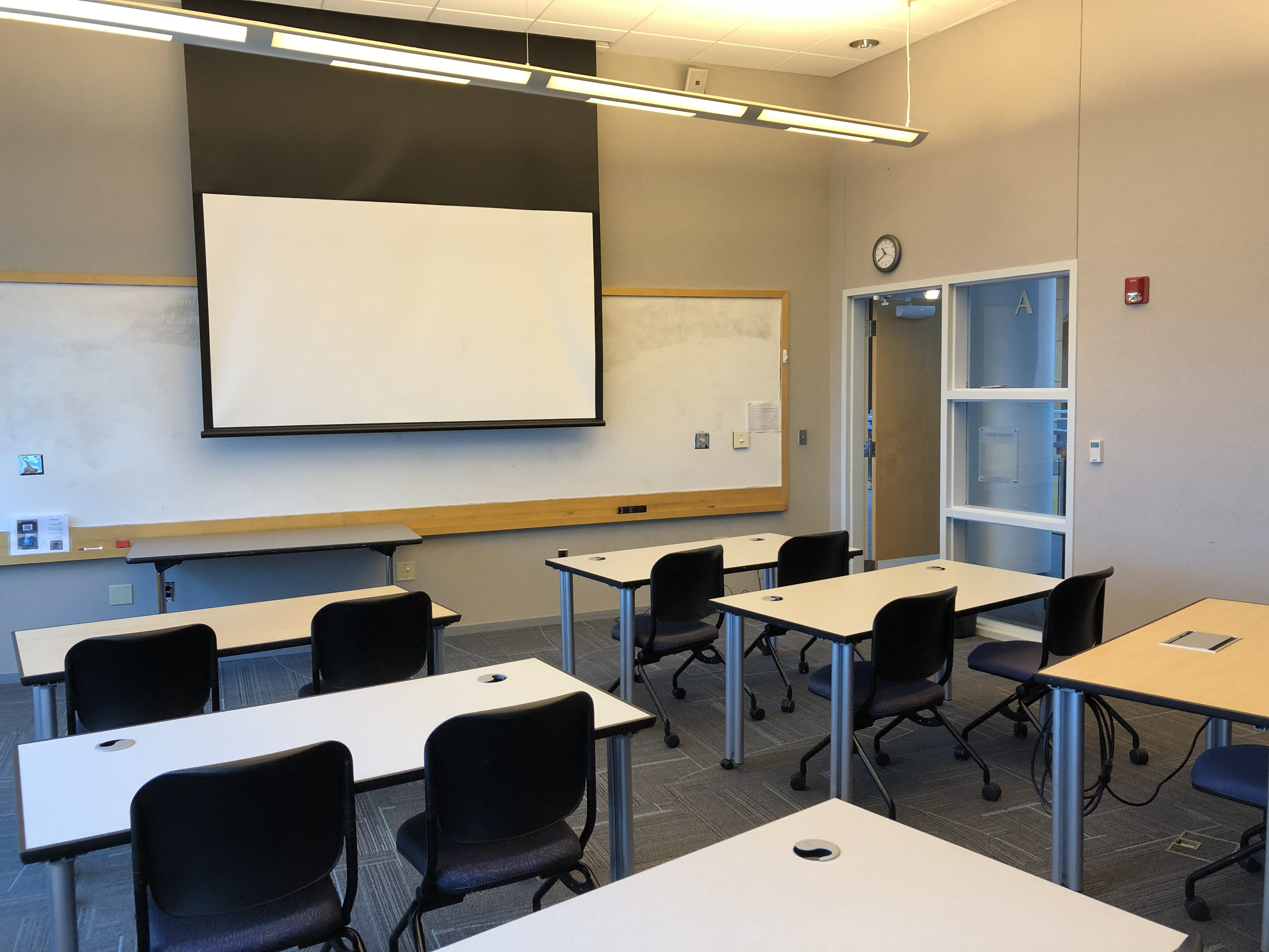 Classroom D with classroom-style seating and large screen at front of room