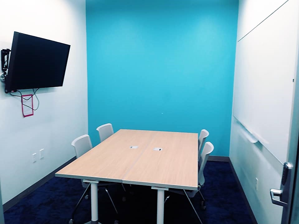 study room with 4 chairs and a tv and a whiteboard