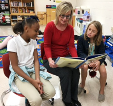 Danyeur reading to two young girls