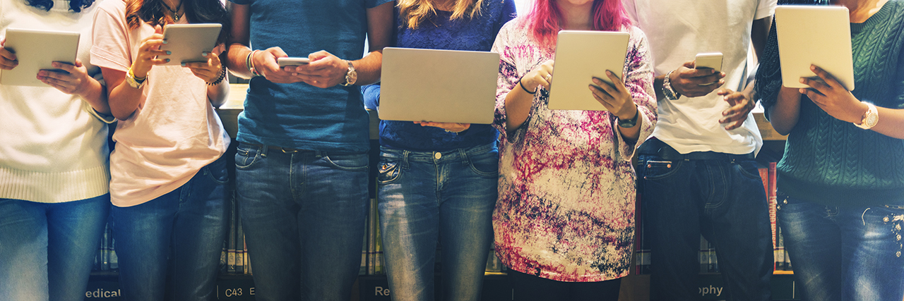 People standing in line holding mobile devices