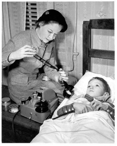 Librarian with project book film and bed-bound boy