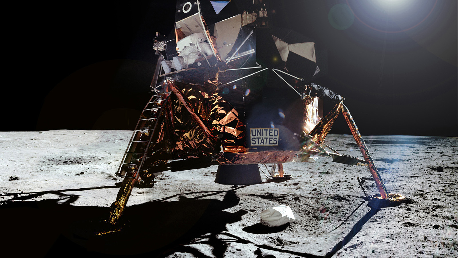 Lunar lander with astronaut emerging.