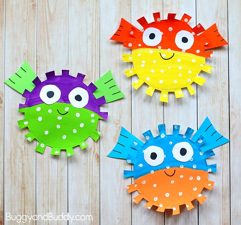3 colorful pufferfish made of paint on paper plates