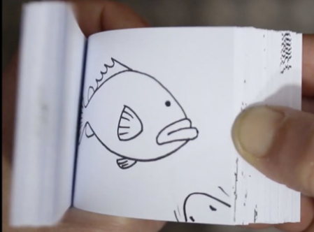 a drawing of a fish in a page of an open flip book