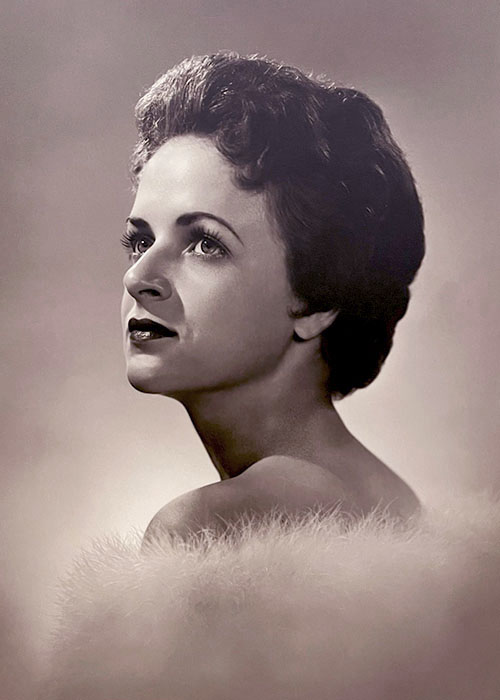 Photographic portrait of a white woman with brown hair; do you know who this is?