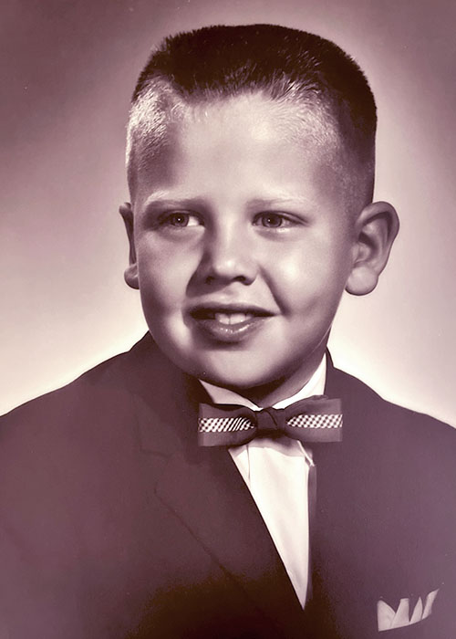Photographic portrait of a white boy, approximately 7-11 years old. 