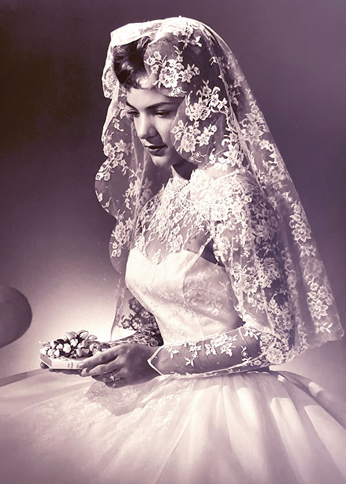 Photographic portrait of an unknown bride in her wedding dress with veil.