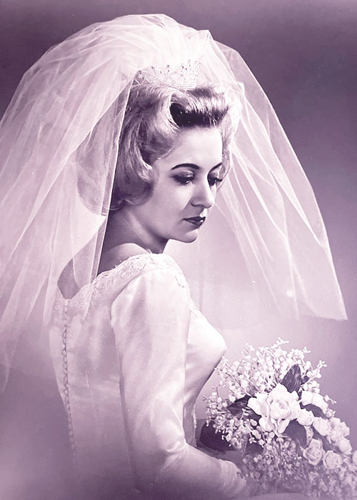 Photographic portrait of an unknown bride in her wedding dress with veil.