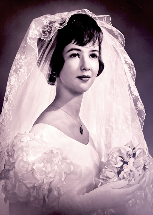 Photographic portrait of an unknown bride in her wedding dress with veil.