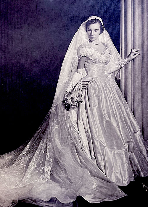 Photographic portrait of an unknown bride in her wedding dress with veil.