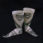 Two 1 dollar bills folded into origami boots