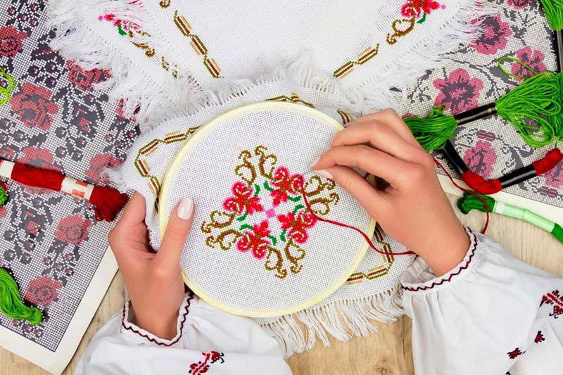 Hands making embroidery, from https://authenticukraine.com.ua/en/traditions-crafts