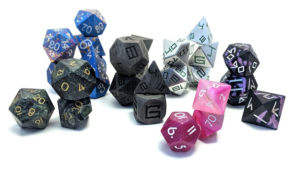 Picture of a variety of dice used in tabletop gaming in a variety of colors