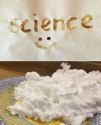 the word "science :)" burned into paper via heated lemon juice and soap that has expanded into a fluffy blob, like white cotton candy, on a plate.