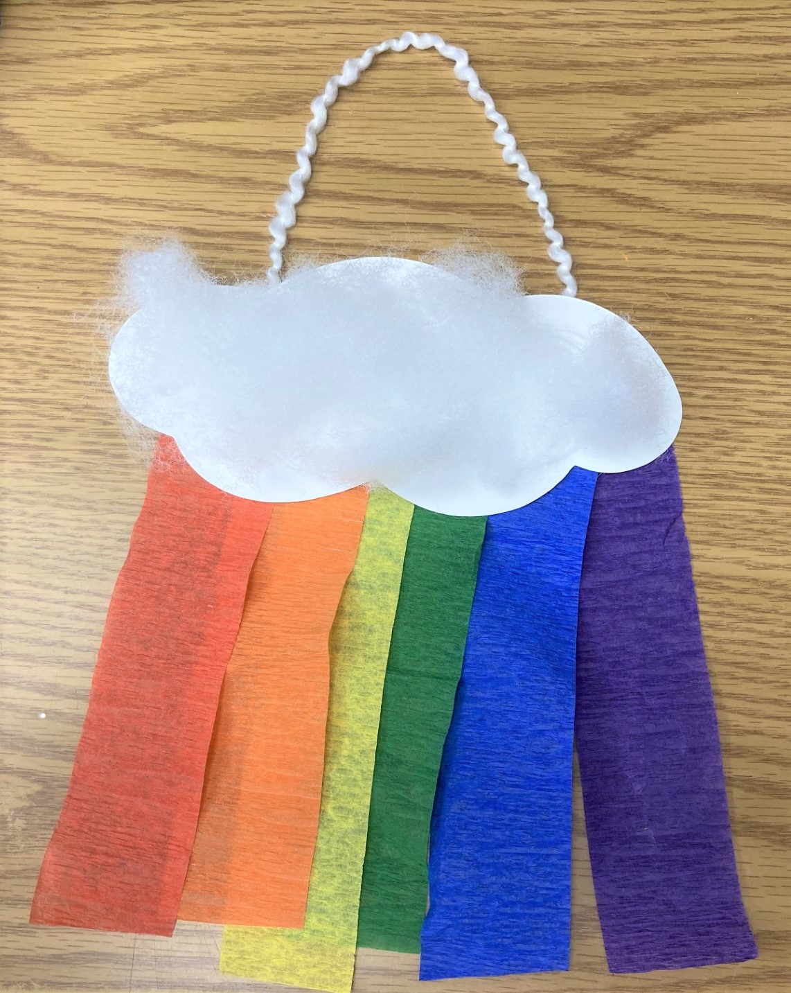 Photo of puffy cloud with rainbow