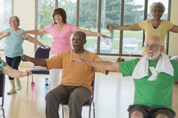 older adults, both standing and sitting, working out