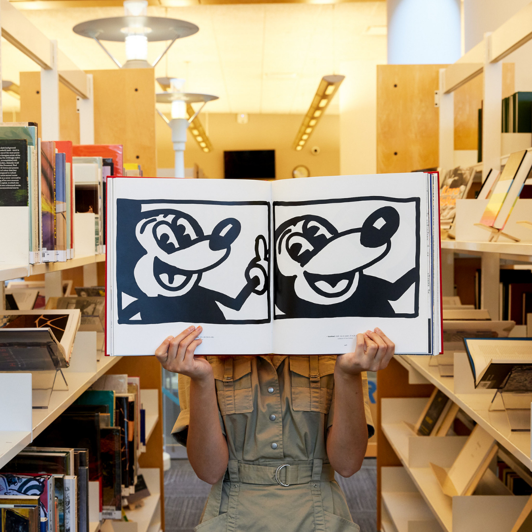 Metropolitan Library System Contemporary Art Reference Library sponsored by the Kirkpatrick Foundation / photo of book open of mickey mouse