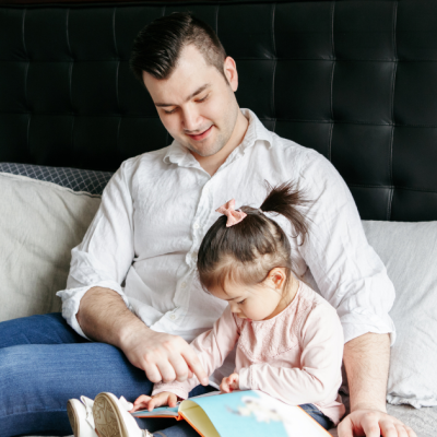 man reading to his child