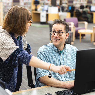 A librarian helping a guest 