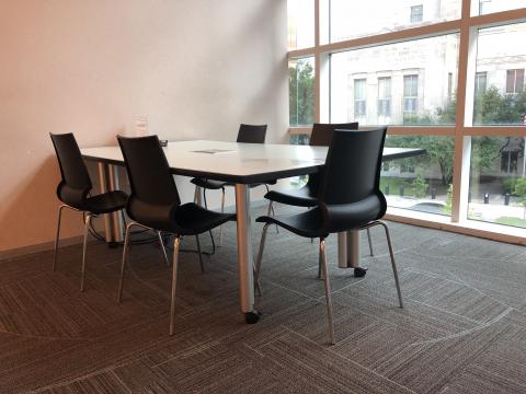 Study Room A with small rectangular table with a wall made of windows