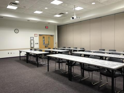 Meeting room B at Edmond Library with rows of tables and chairs