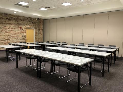 Meeting room A at Edmond Library with rows of rectangular tables and chairs