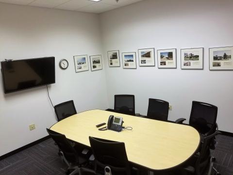 Conference room with 7 chairs around a table