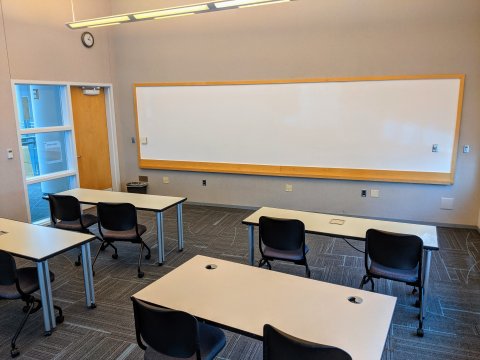 Classroom E with classroom-style seating and whiteboard