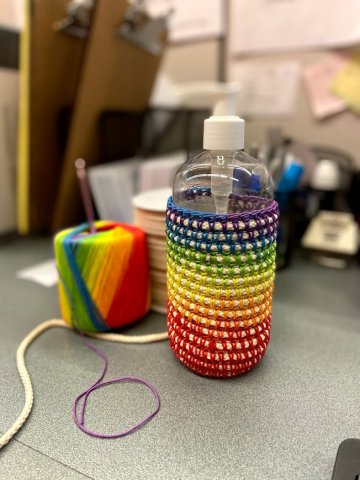 A crochet basket in rainbow colors