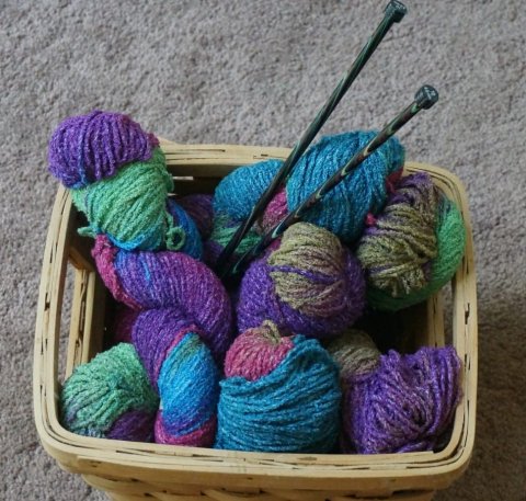 Knitting basket with multicolored yarn and needles