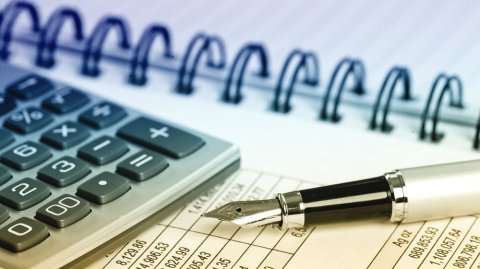 image of calculator, fountain pen, financial records