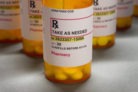 close up of orange Rx bottle with white label
