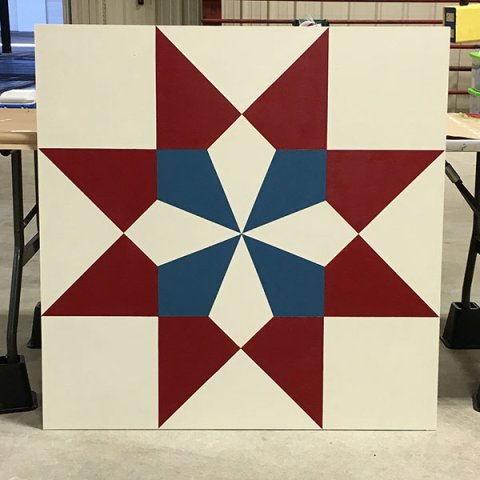 Pictured is an example of a painted barn quilt square.