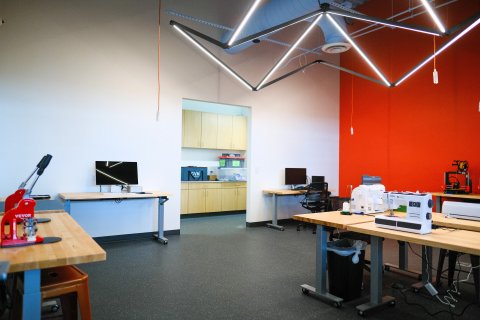 The makerspace at Almonte Library showing computers, a 3d printer, a sewing machine, an embroidery machine, a Cricut machine, and a button maker