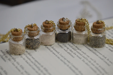 a sample of the craft project, 6 small vials filled with sand/jars