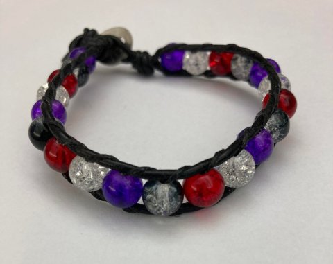 Wrap bracelet made with glass beads, waxed thread, and leather cord.