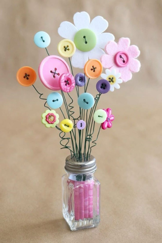 Vase of flowers made out of buttons.