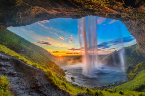 waterfall and rock formation at sunset
