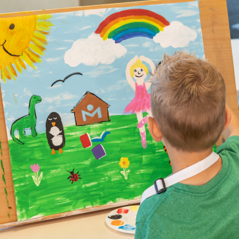 Young child painting.
