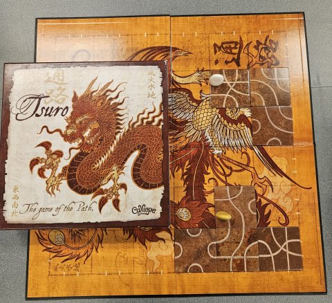 board game called Tsuro presented with lined tiles laid out on the board with small dragon tokens
