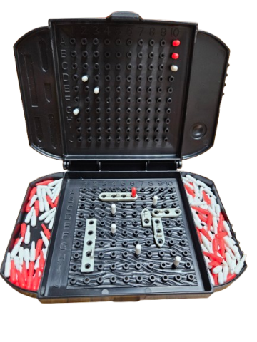 Image of the board game Battleship. One player's board is open to show ships on a grid with red and white markers in place.