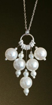 Faux Pearls on wires, hanging on a necklace chain.