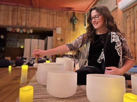 Sound bath presenter using a singing bowl.