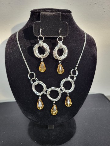 Chainmail Earrings and Necklace with beads, on a jewelry stand.