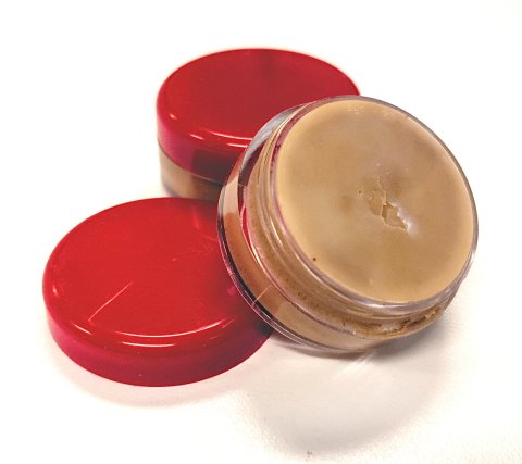 Homemade cinnamon lip balm in a small container