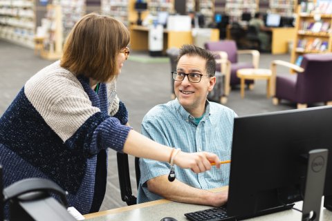 A librarian helping a guest 