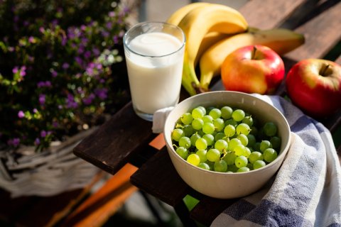 Photo of foods like milk, grapes, apples, bananas, carrots, and other health choices.