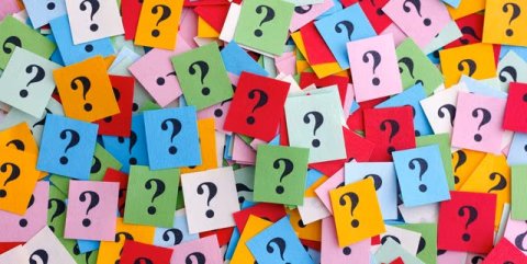 Question marks on brightly colored paper squares.