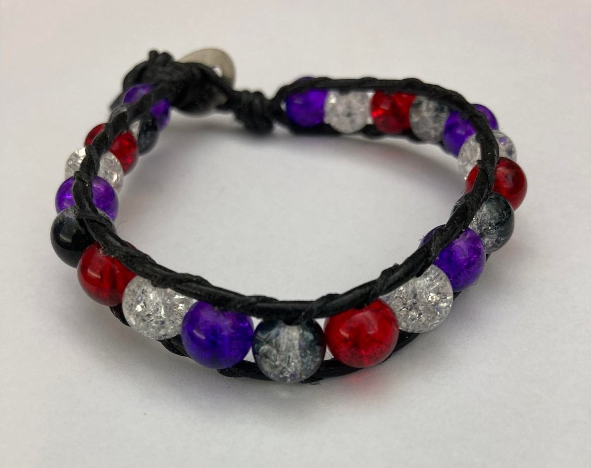 Wrap bracelet made with glass beads, waxed thread, and leather cord.